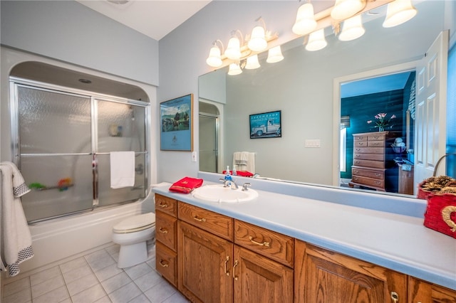 full bathroom featuring tile floors, shower / bath combination with glass door, toilet, and vanity