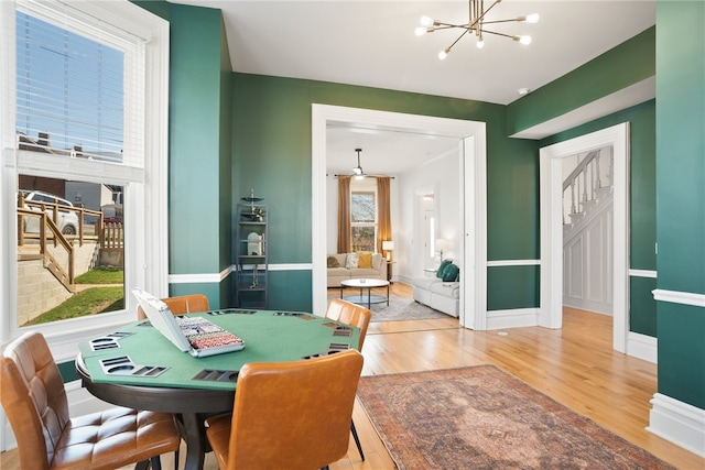 dining room with a notable chandelier and light hardwood / wood-style floors