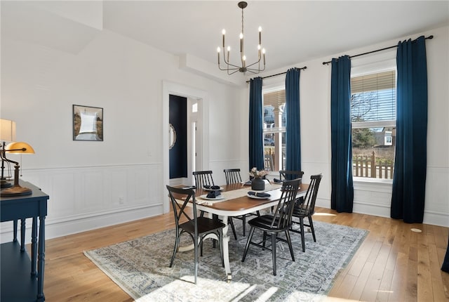 dining space featuring light hardwood / wood-style flooring and an inviting chandelier