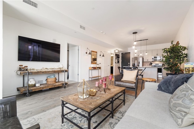 living room with light hardwood / wood-style flooring