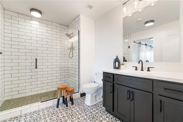 bathroom featuring vanity, tile floors, toilet, and walk in shower