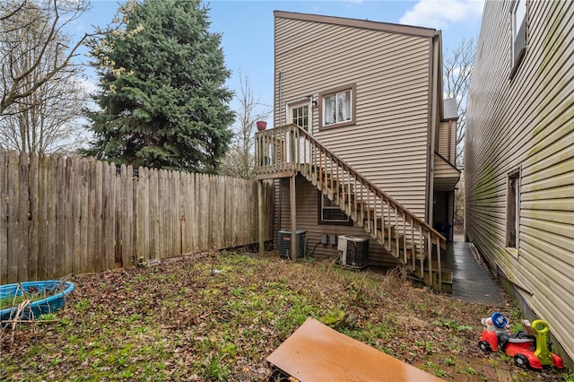 back of house featuring central AC unit