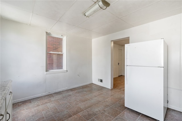 unfurnished room featuring a paneled ceiling