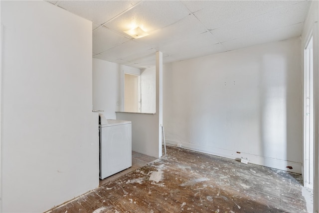 unfurnished room featuring a drop ceiling