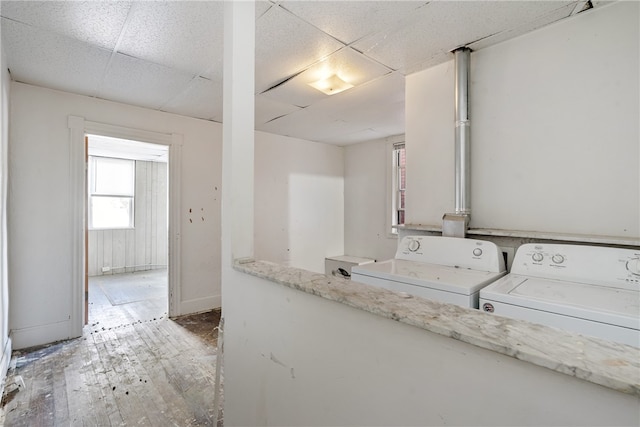 laundry room with hardwood / wood-style flooring and independent washer and dryer