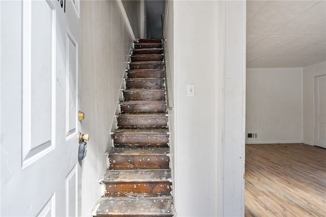 stairs with wood-type flooring