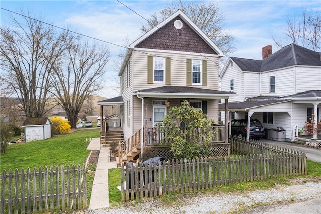 view of property with a porch, a shed, and a front lawn