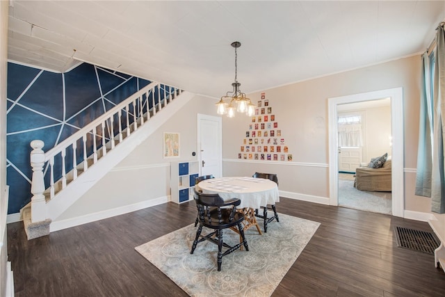 dining space with a notable chandelier and dark hardwood / wood-style floors