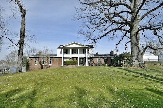 rear view of house with a yard