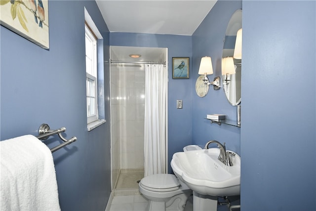 bathroom with a shower with curtain, toilet, tile floors, and sink