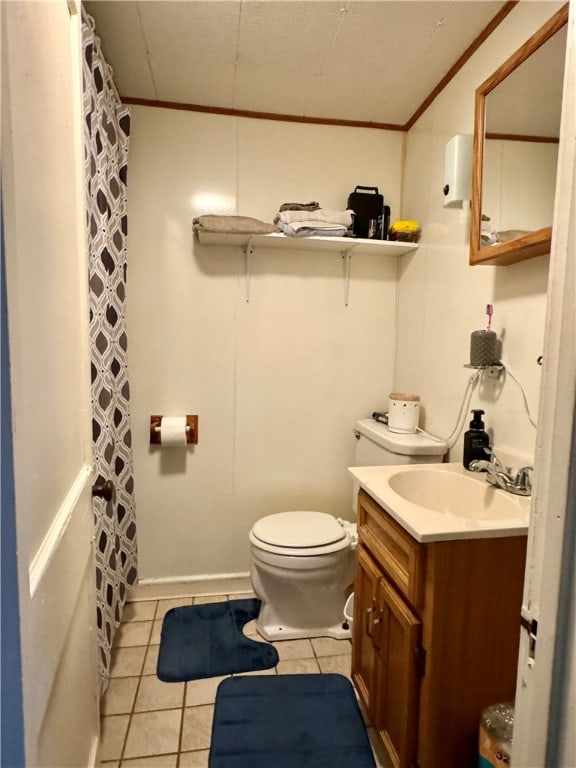 bathroom featuring tile floors, toilet, vanity, and crown molding