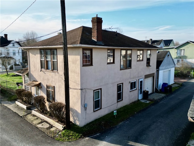 view of side of property with a garage