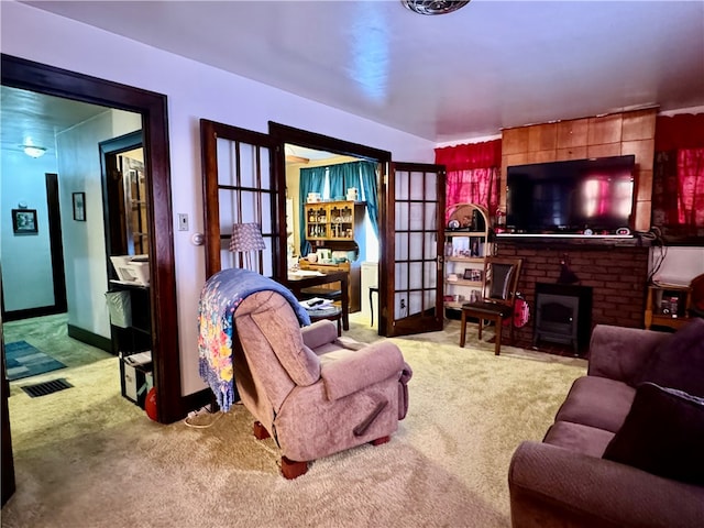 carpeted living room featuring french doors and a wood stove