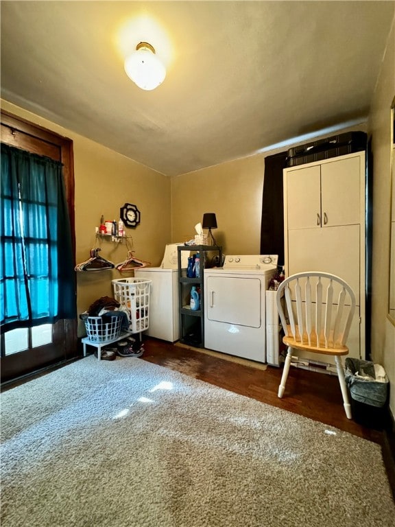 laundry room featuring dark wood-type flooring and washing machine and clothes dryer