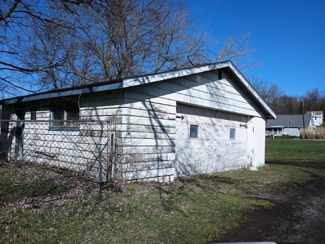 view of side of home featuring a lawn