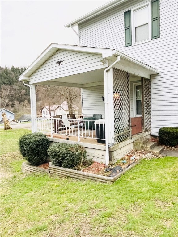 rear view of property featuring a yard