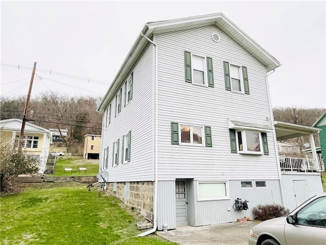 view of property exterior featuring a lawn