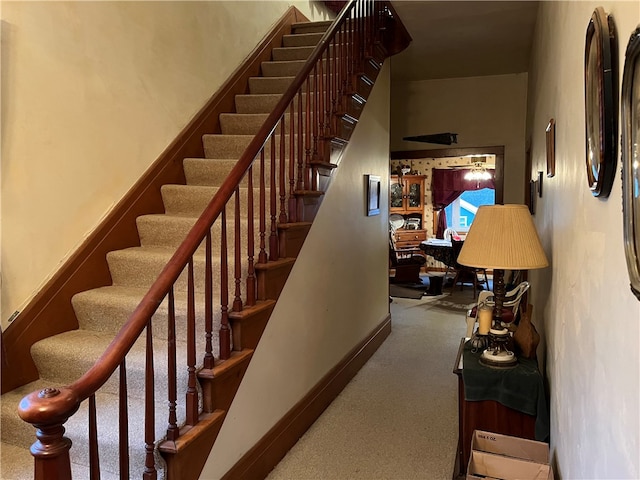 staircase with carpet flooring and a high ceiling