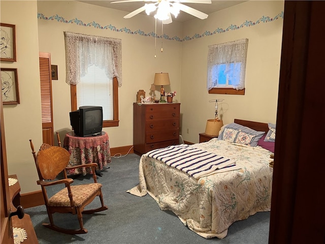 bedroom featuring ceiling fan and dark carpet