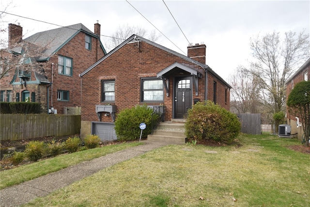 view of front of house with a front yard and central air condition unit