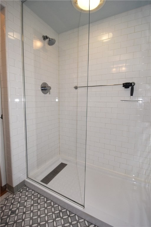 bathroom featuring tile patterned floors and a shower with door