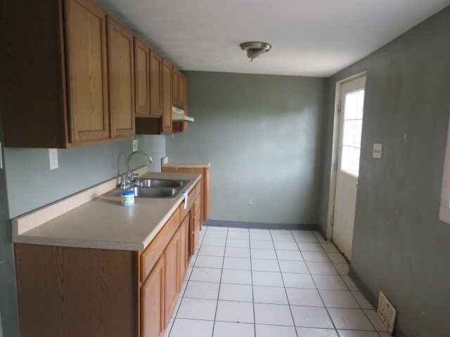 kitchen with sink and light tile floors