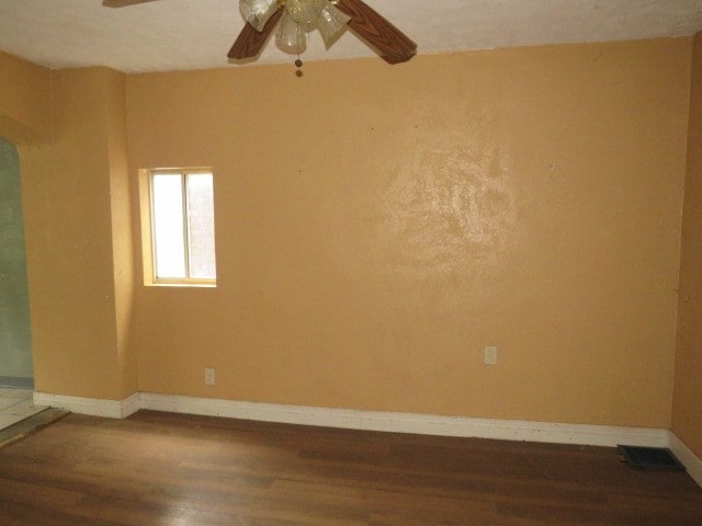 unfurnished room with ceiling fan and wood-type flooring