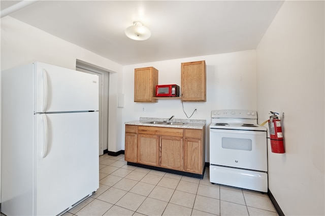 kitchen featuring light tile floors, white appliances, and sink