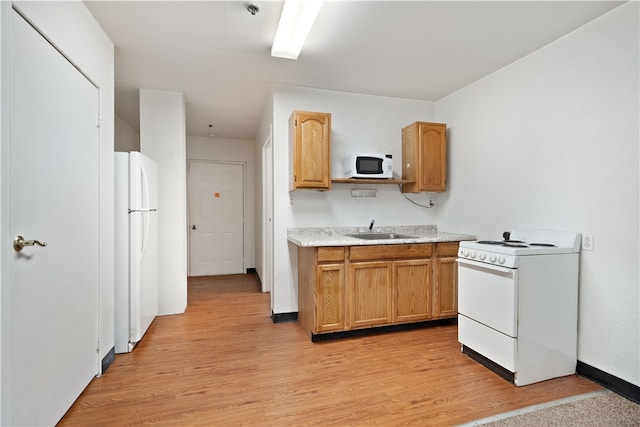 kitchen featuring light hardwood / wood-style floors, white appliances, sink, and light stone countertops