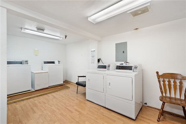 laundry area with independent washer and dryer and light wood-type flooring