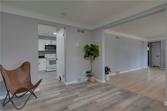 unfurnished room with light wood-type flooring