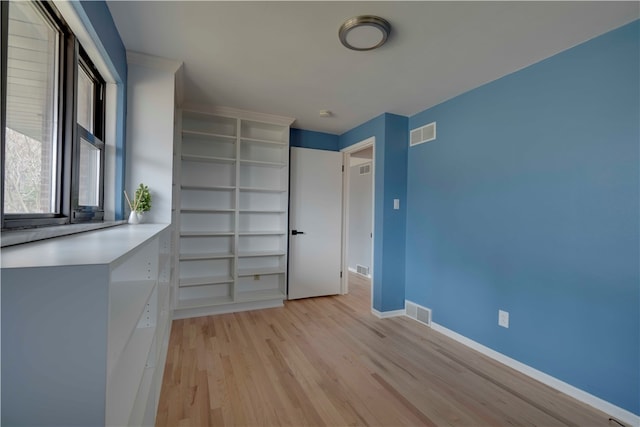 unfurnished bedroom with light wood-type flooring