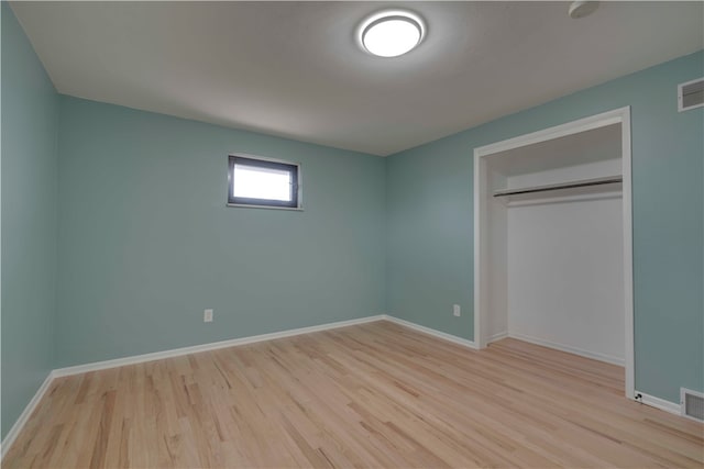 unfurnished bedroom with light hardwood / wood-style floors and a closet