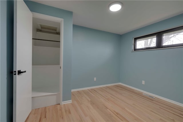 unfurnished bedroom with light wood-type flooring