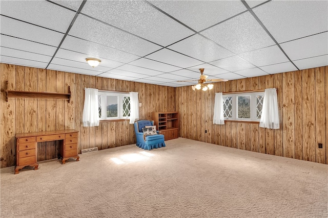 misc room featuring carpet floors, ceiling fan, and a paneled ceiling