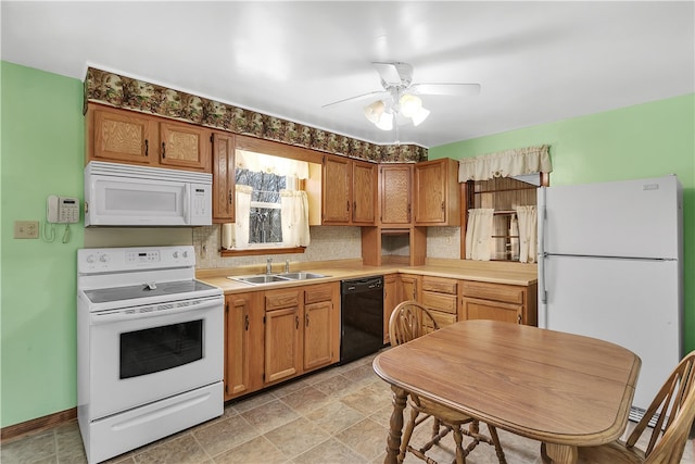 kitchen featuring light tile floors, ceiling fan, white appliances, and sink