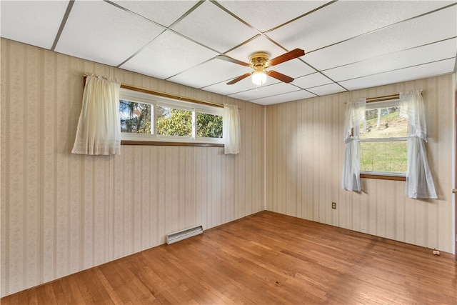 spare room with light hardwood / wood-style floors, ceiling fan, and a wealth of natural light