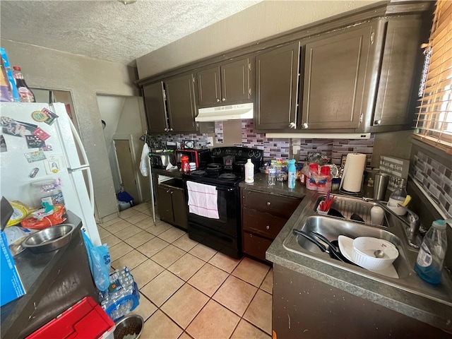 kitchen with black electric range oven, white refrigerator, light tile patterned floors, a textured ceiling, and tasteful backsplash