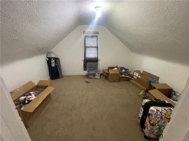 bonus room featuring a textured ceiling, carpet floors, and lofted ceiling