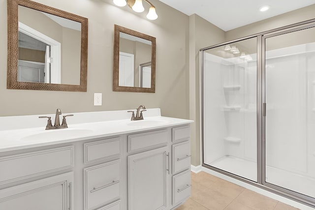 bathroom featuring vanity, an enclosed shower, and tile patterned flooring