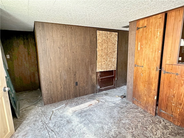 unfurnished room with wooden walls