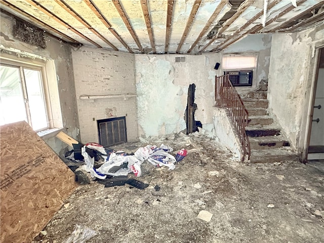 miscellaneous room with a brick fireplace