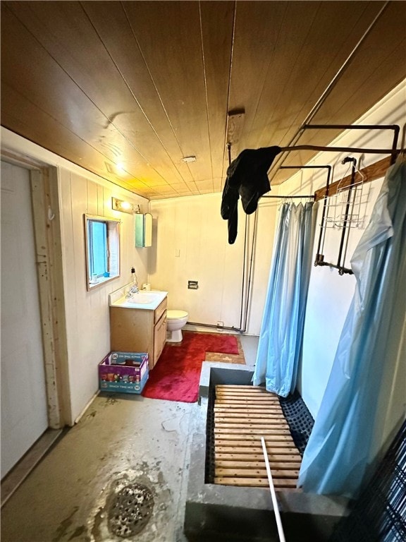 interior space featuring wood walls, wooden ceiling, and sink