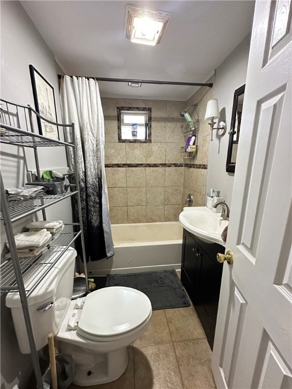 full bathroom featuring toilet, tile flooring, vanity, and shower / bath combo with shower curtain