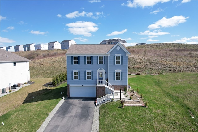 view of front of property with a front yard and a garage