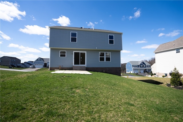 rear view of house featuring a lawn and a patio area