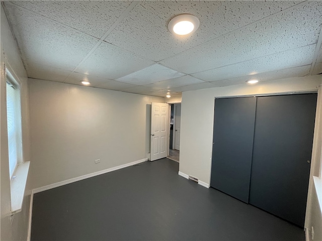 basement with a paneled ceiling