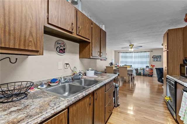 kitchen featuring ceiling fan, light hardwood / wood-style floors, and sink