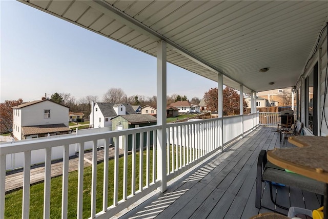 wooden terrace with a lawn