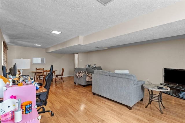 home office featuring hardwood / wood-style flooring and a textured ceiling